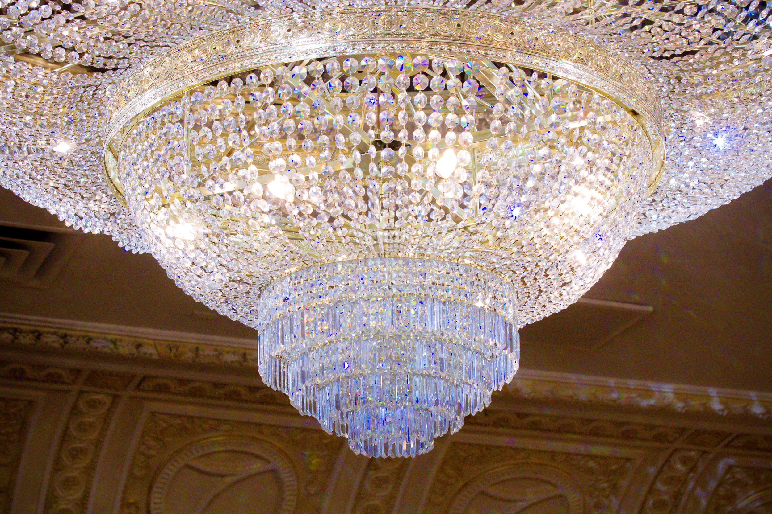 Large crystal chandelier inside an elegant wedding venue