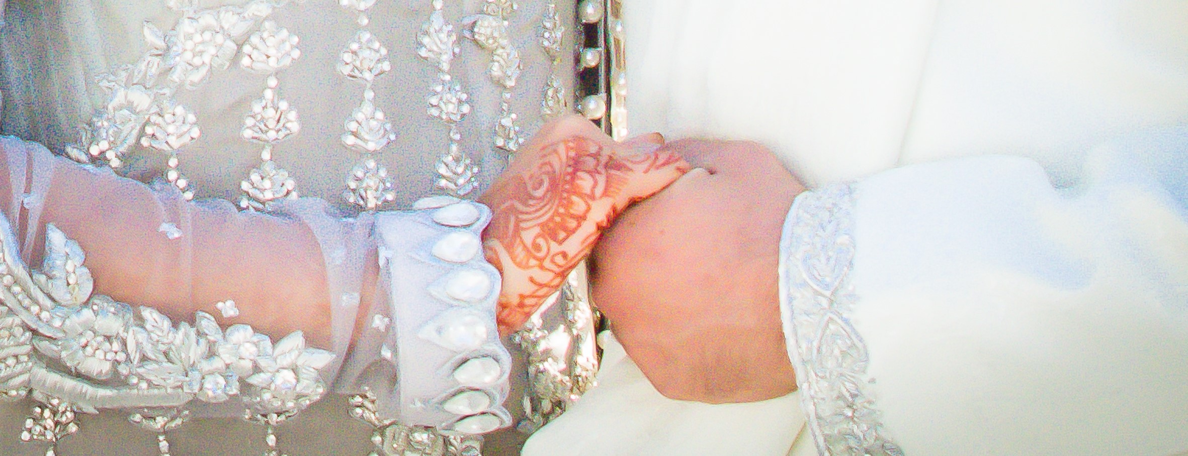 Close-up of the bride and groom holding hands during a traditional wedding ceremony