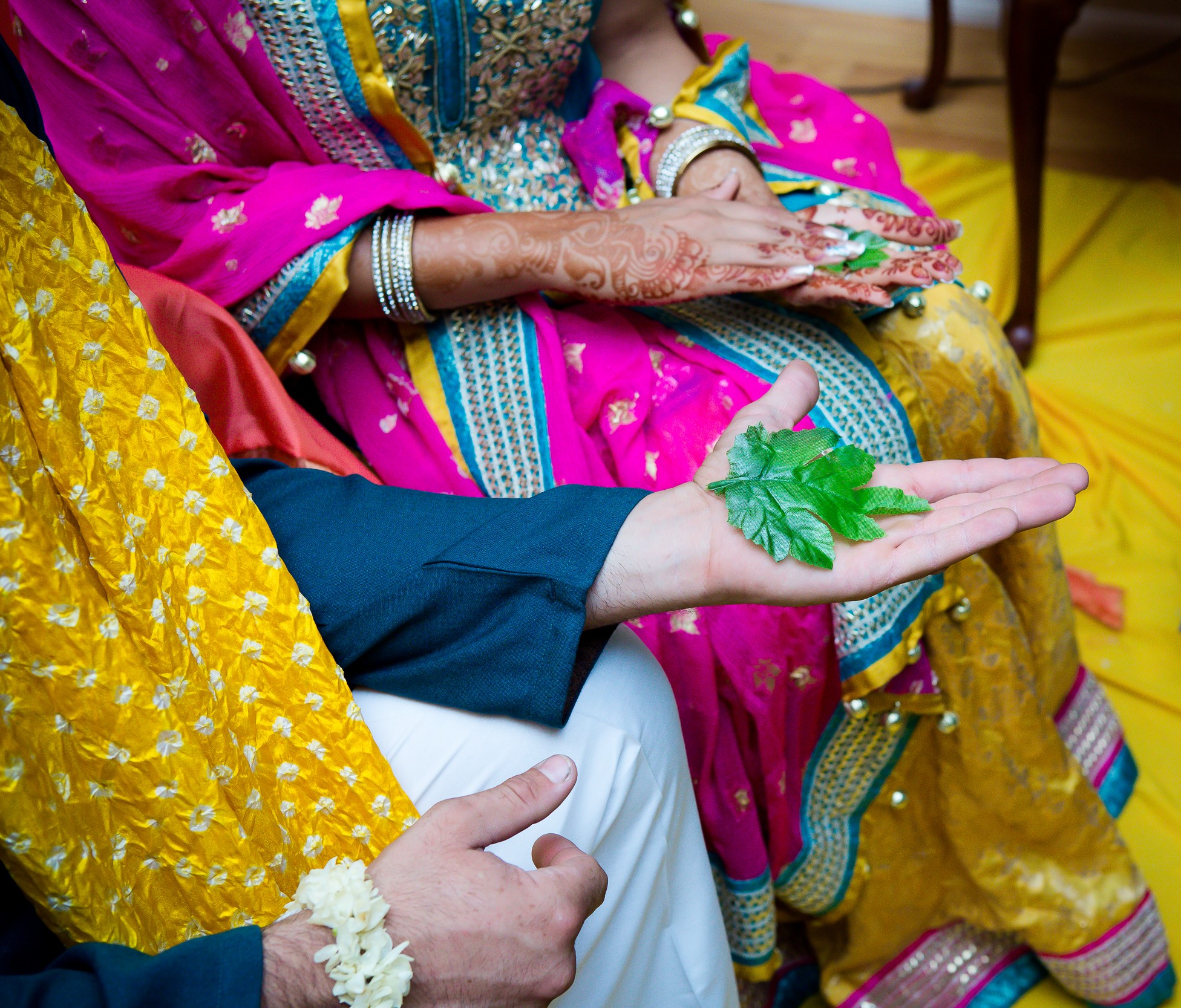 Bride and groom seated during a traditional wedding ritual with family members