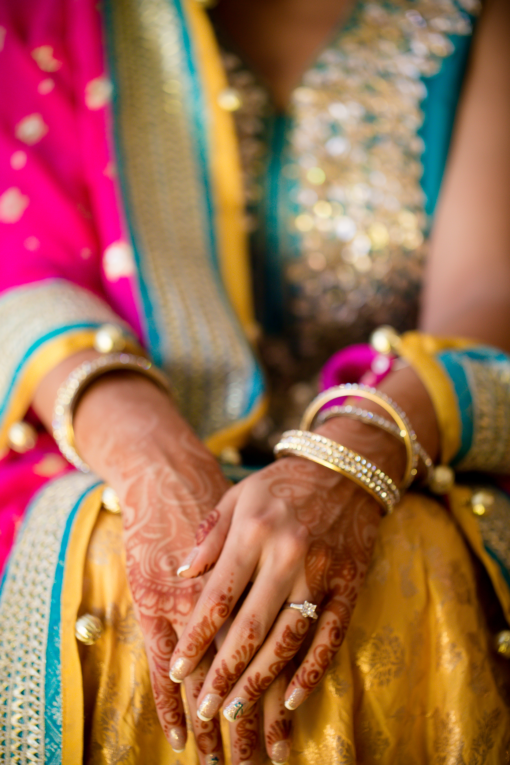 Bride in traditional wedding clothing with henna on her hands